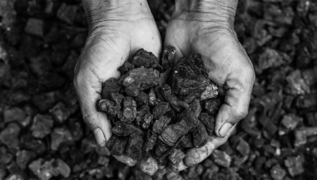 Hands holding steam coal